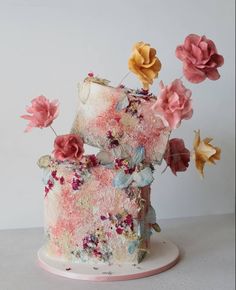 a cake decorated with flowers on top of a white plate