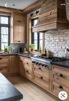 a kitchen with wooden cabinets and black counter tops, along with an island in the middle