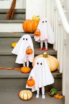 halloween decorations on the steps with ghost and pumpkins