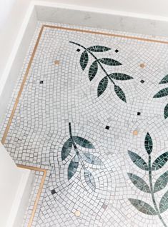 the floor is made up of tiles with leaves and dots on them, as well as gold trimmings