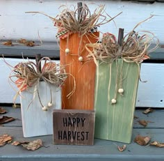 three wooden bags with happy harvest decorations on them