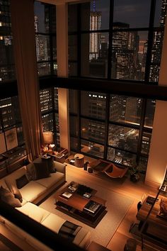 a living room filled with lots of furniture and tall buildings in the background at night