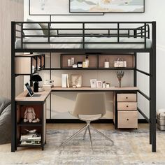 a loft bed with desk underneath it in a room next to a couch and chair