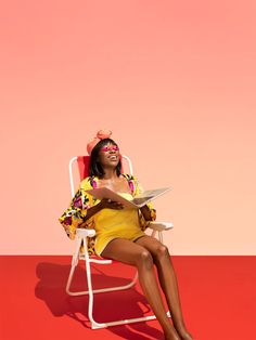 a woman in a yellow dress sitting on a white chair