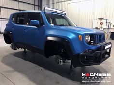 a blue jeep is parked in a garage