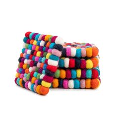 multicolored pom pom clutch bag on white background