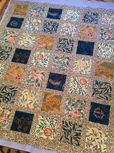 an antique quilt is displayed on a table