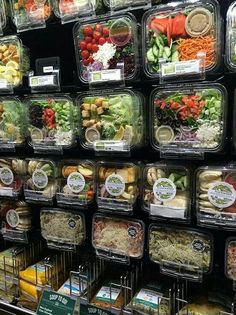 a display case filled with lots of different types of food in plastic containers on shelves