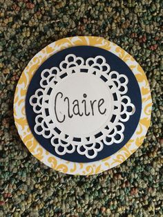 a paper plate with the word caare on it sitting on a carpeted floor