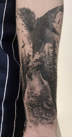 a man with a wolf and eagle tattoo on his arm