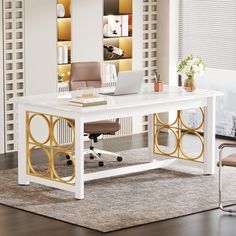 a white and gold office desk with a laptop on it in front of a window