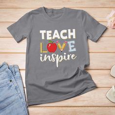 a t - shirt that says teach love inspire with an apple