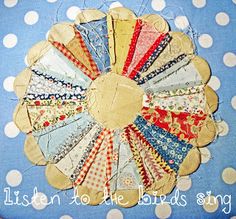 a circular piece of fabric on top of a blue and white polka dot table cloth