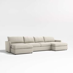 a white sectional couch sitting on top of a white floor