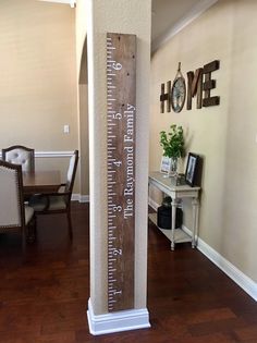 a tall wooden ruler is in the middle of a room