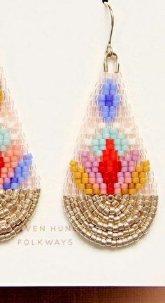 a pair of colorful beaded earrings hanging from hooks