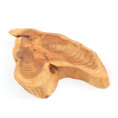 a piece of wood that is shaped like an animal's head on a white background