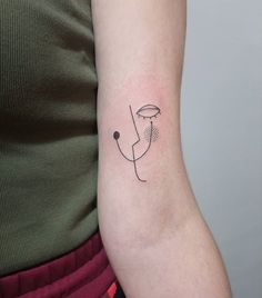 a woman's arm with a single line drawing on the left side of her arm