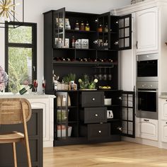 a kitchen with black cabinets and white walls