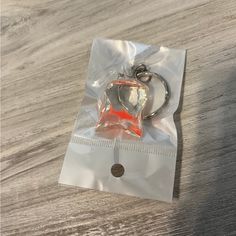 a plastic bag with a keychain in it