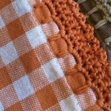 an orange and white checkered blanket sitting on top of a table