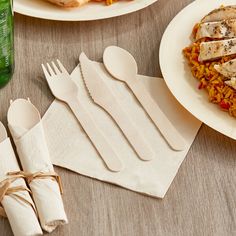 two plates with forks, spoons and napkins next to each other on a table