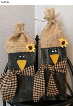 two black birds with sunflowers on their heads are sitting in front of a door