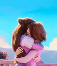 two people hugging each other in front of a blue sky