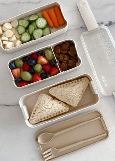 three plastic containers filled with different types of food on top of a marble countertop