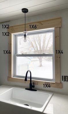 a kitchen sink and window with measurements for the windowsills above it in front of them