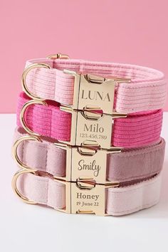 three pink and gold bracelets with personalized tags on each one, along with a name plate