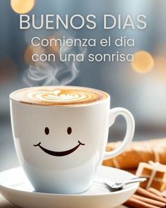 a cup of coffee with a smiley face on it and the words, buenbosdias commenza el dia con una sonrisa