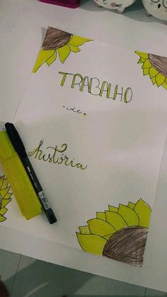 there is a yellow marker sitting on top of a paper that says traenho