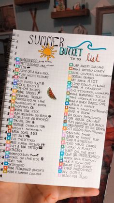 someone holding up a summer bucket list