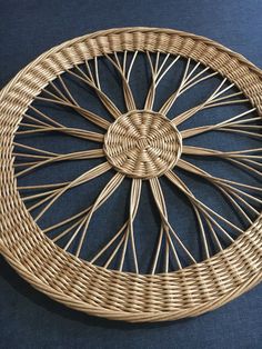 a wicker wheel on a blue surface