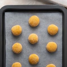 doughnut holes on a baking sheet ready to go into the oven