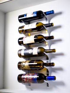 several bottles of wine are hanging on the wall