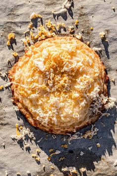 an uncooked pizza sitting on top of a table covered in cheese and other toppings