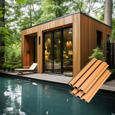 a small pool house in the middle of a wooded area next to a swimming pool