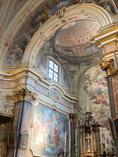 the interior of an old church with paintings on the walls