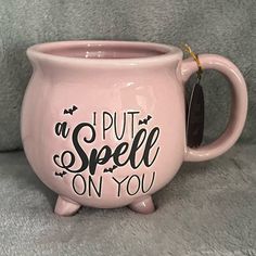 a pink coffee mug that says, i put spell on you