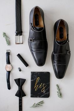 men's accessories laid out on a white surface including shoes, watch and tie