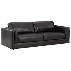 a black leather couch sitting on top of a white floor