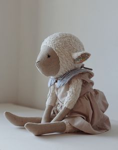 a stuffed animal sitting on top of a white floor next to a window sill