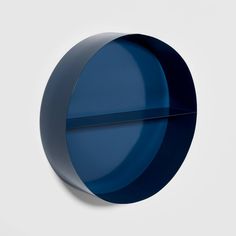 a blue circular object on a white wall