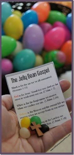 a person holding up a card that says the jelly bean gospel in front of colorful balls