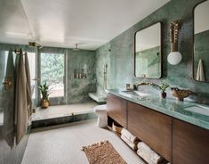 a bathroom with green walls and marble counter tops