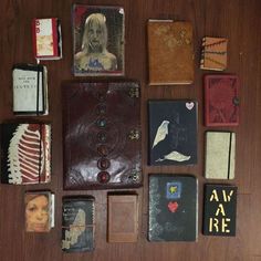 many different types of books are laid out on a table together, including one with a woman's face