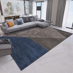 a modern living room with grey couches and blue rugs on the floor in front of large windows