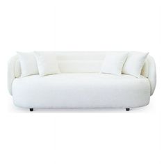 a white couch with three pillows on it's back and one pillow sitting on the top